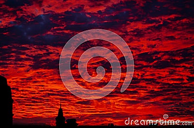 Red bloody sunset in cloudy sky above the village. beautiful countryside landscape Stock Photo