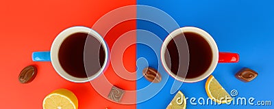 Red and blue cups with tea , lemon slices and chocolate candies Stock Photo