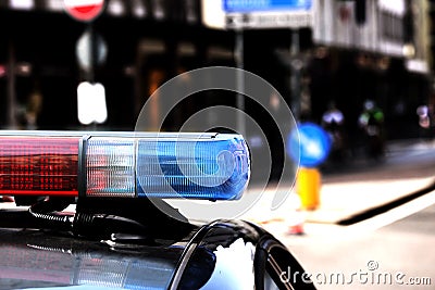 Red and blue flashing lights of the police car in the checkpoint Stock Photo