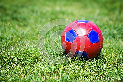 Red and blue fotball on grass Stock Photo