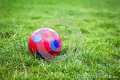 Red and blue fotball on grass Stock Photo