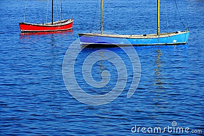 Red and Blue Sailboats Floating in Ocean Water Lake Boat Stock Photo