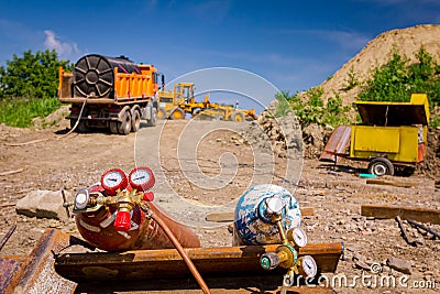 Metal gas acetylene cylinder containers with oxygen and nitrogen placed on the construction site Editorial Stock Photo