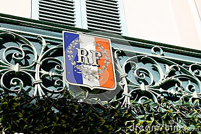 Red blue white French coat of arms flag on city hall in france facade building in town Editorial Stock Photo