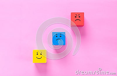 Cubes with cute faces depicting human emotions: anger, sadness and happiness Stock Photo