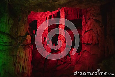 Red blurred abstract background of stalactites, stalagmites and stalagnates in a cave underground, horizontal Stock Photo