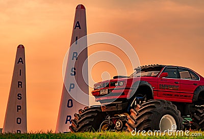 Red BMW car 4x4 bigfoot parked on green grass in Air Race 1 World Cup Thailand 2017 at U-Tapao Naval Air Base Editorial Stock Photo