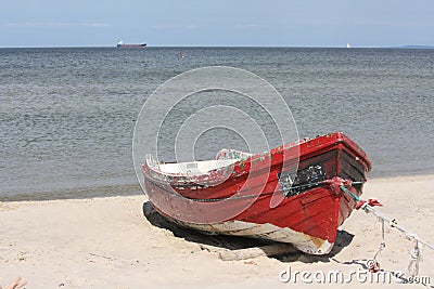 A red boat on a beach Stock Photo