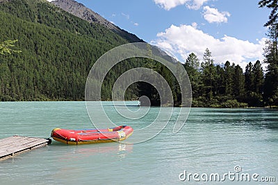 Red boat at the pier, Kucherlinskoe Lake, Belukha Natural Park, Altai Mountains, Russia Stock Photo