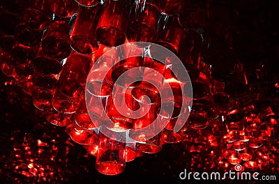 Red Bottles glowing under the ceiling Stock Photo