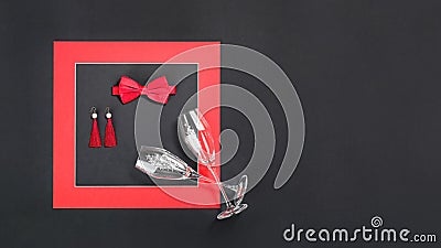Red bow tie earings and flute glasses flat lay for 14 February date Stock Photo