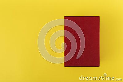 Red box on yellow background top view. Red rectangle on yellow background. Copy space. Mock up Stock Photo