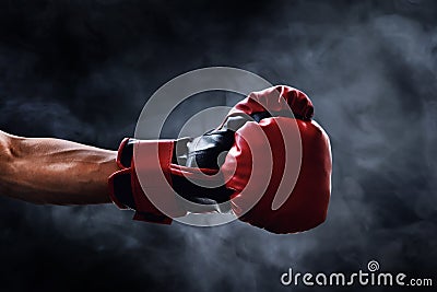 Red boxing glove on smoke backgrounds Stock Photo