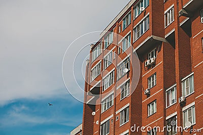 red brick apartment building against a blue sky Stock Photo