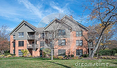 Red Brick and Gray Three Story Apartment Complex Stock Photo