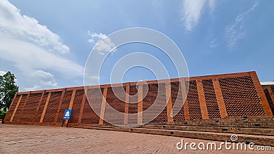 Red brick architectural building on bright blue sky background Stock Photo