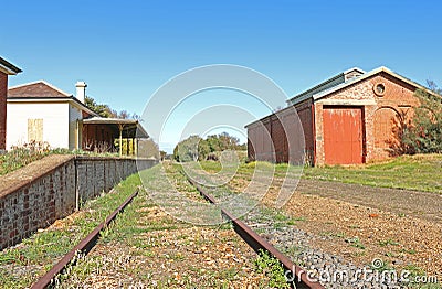 Red-brick railway station building, goods shed and platform Stock Photo