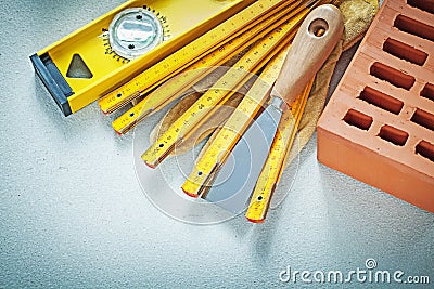 Red brick safety gloves putty knife construction level wooden me Stock Photo