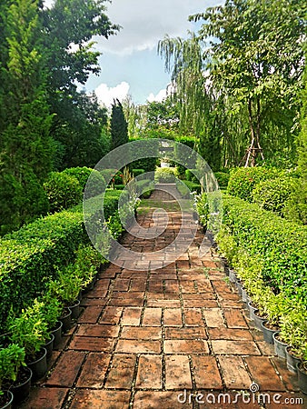 Red brick walking path in Englidh Garden Stock Photo