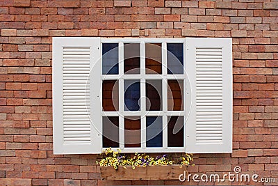 Red brick wall with white window. Stock Photo