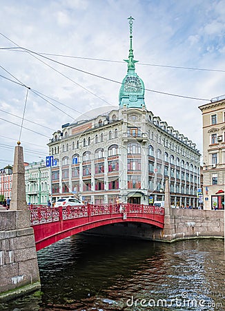 Red bridge on the Moyka river and former Esders and Scheefhals trading house building. Editorial Stock Photo