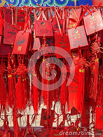 Red buddhists praying and hanging traditional wishing cards Editorial Stock Photo