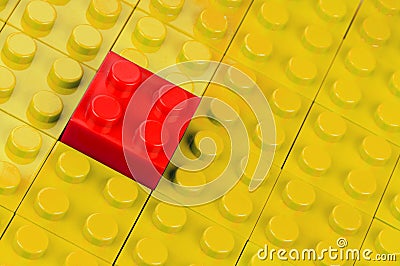 Red building block in yellow Stock Photo