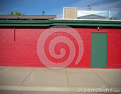 Red building with green door Stock Photo