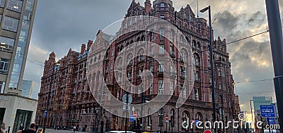 Red building standing tall in the heart of Manchester. Editorial Stock Photo