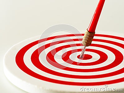 Red bullseye dart arrow hitting target center of dartboard. Concept of success, target, goal, achievement. Stock Photo