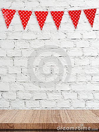 Red bunting party flag with heart shape pattern hanging over empty table background Stock Photo