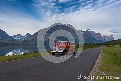 Red Bus in front of Red Eagle Mountain Editorial Stock Photo