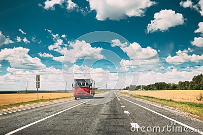 Red Bus In Motion On Country Road. Motion Cars On Freeway In Europe. Asphalt Freeway, Motorway, Highway Through Fields Stock Photo