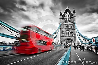 Red bus in motion on Tower Bridge in London, the UK Editorial Stock Photo
