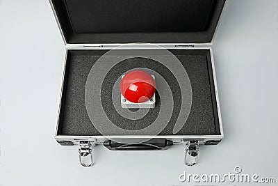 Red button of nuclear weapon in suitcase on white background, above view. War concept Stock Photo