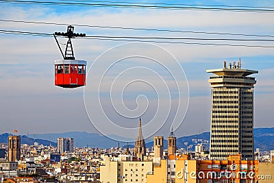 Red cabin of cableway stands out on the skyline of Barcelona Stock Photo