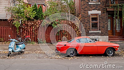 Red cadillac and blue Vespa Stock Photo