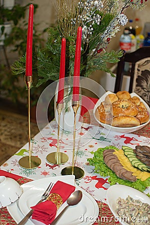 red candles on golden candlesticks, decorative element of the festive table Stock Photo