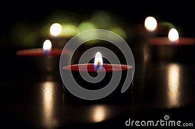 Red candles glowing in the night Stock Photo