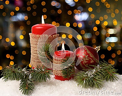 Red candles on white snow. Boke in the background. Christmas decoration. Stock Photo
