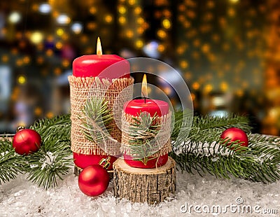 Red candles on white snow. Boke in the background. Christmas decoration Stock Photo