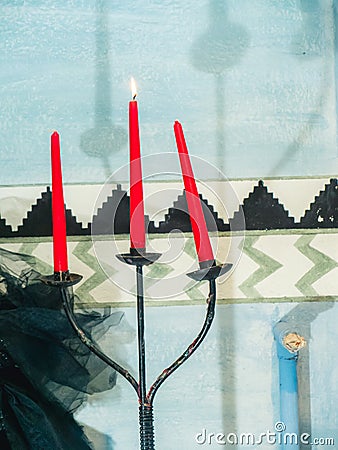 a lit red candle for esoteric spell Stock Photo