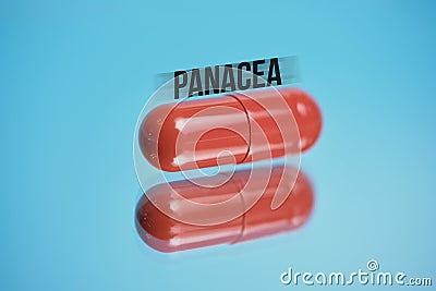 Red capsule with abstract inscription panacea on a blue background Stock Photo