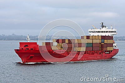 Red cargo container ship at sea. Stock Photo