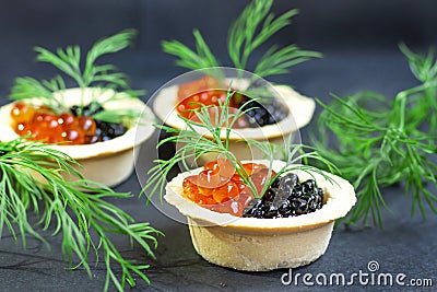 Red caviar and black caviar are in tartlets Stock Photo