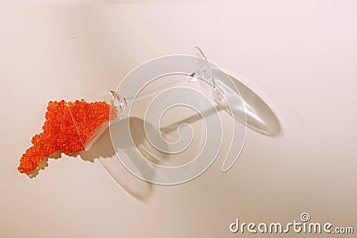Red caviar. Caviar fell out of the glass. A useful omega. A natural product. Caviar of salmon or sturgeon fish.Light Stock Photo