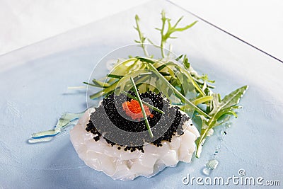 Red caviar, white caviar, fish and rucola Stock Photo