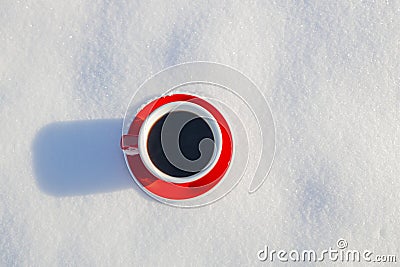 Red ceramic cup of espresso coffee on snow background of a winter landscape Stock Photo