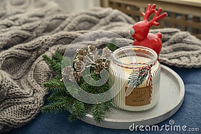 Red ceramic deer and candle in jar with fir tree branches Stock Photo