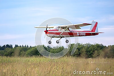 Red Cessna 150 plane is coming in to landing Editorial Stock Photo